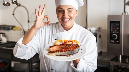 Eine fröhliche Köchin in einer Restaurantküche