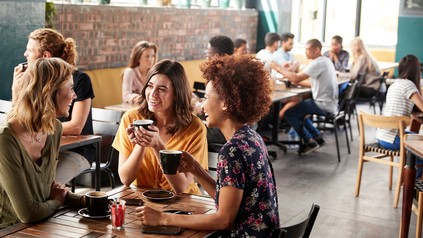 Junge Menschen sitzen in einem Cafe und unterhalten sich