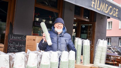 Alexander Moll, Inhaber des Theaters in der Filmdose in Köln, freut sich über die gespendeten Einwegbecher.